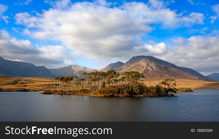 Buitiful Landscape with mountains and sky reflected in lake, Connemara, Ireland