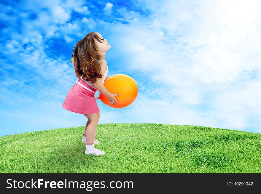 Little Girl Plays With ellow Balloon In Grass