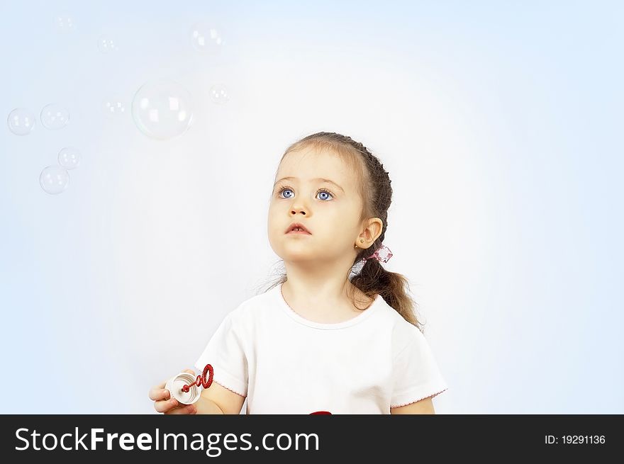 The girl starting up soap bubbles.isolated