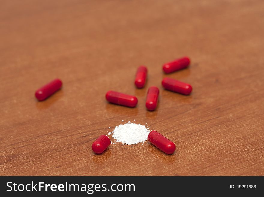 One tablet of red capsules; Narcotics standin in a table. One tablet of red capsules; Narcotics standin in a table