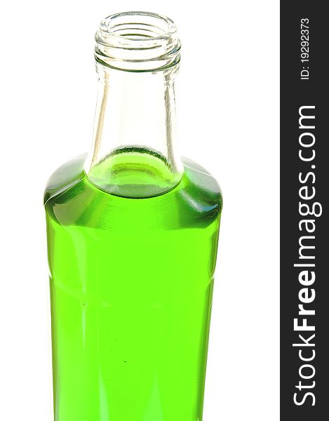 Lemonade of green color in a glass bottle on the white isolated background