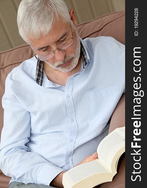 Portrait of senior man reading a book. Portrait of senior man reading a book
