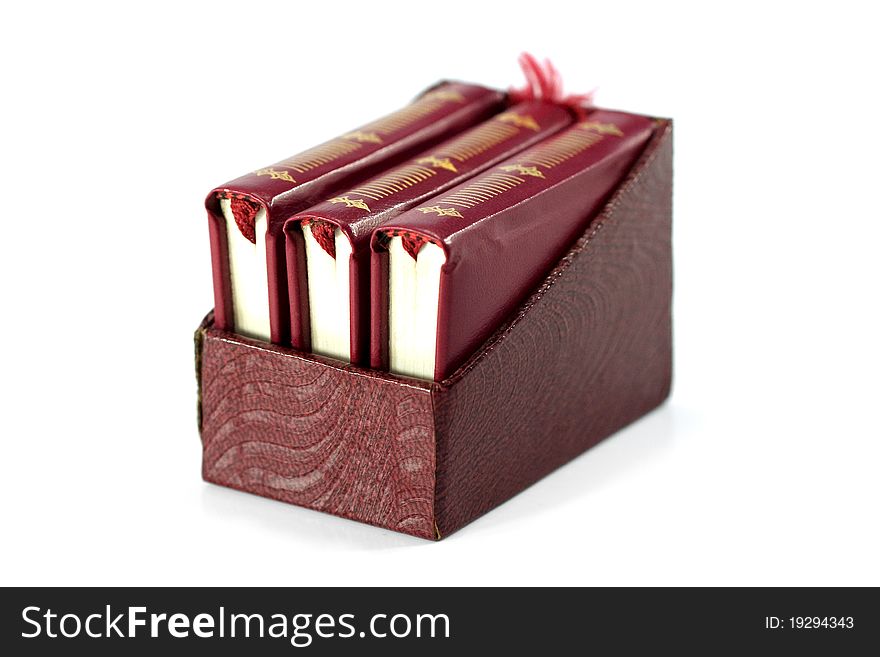 Three miniature book bound in red, enclosed in its case. Three miniature book bound in red, enclosed in its case