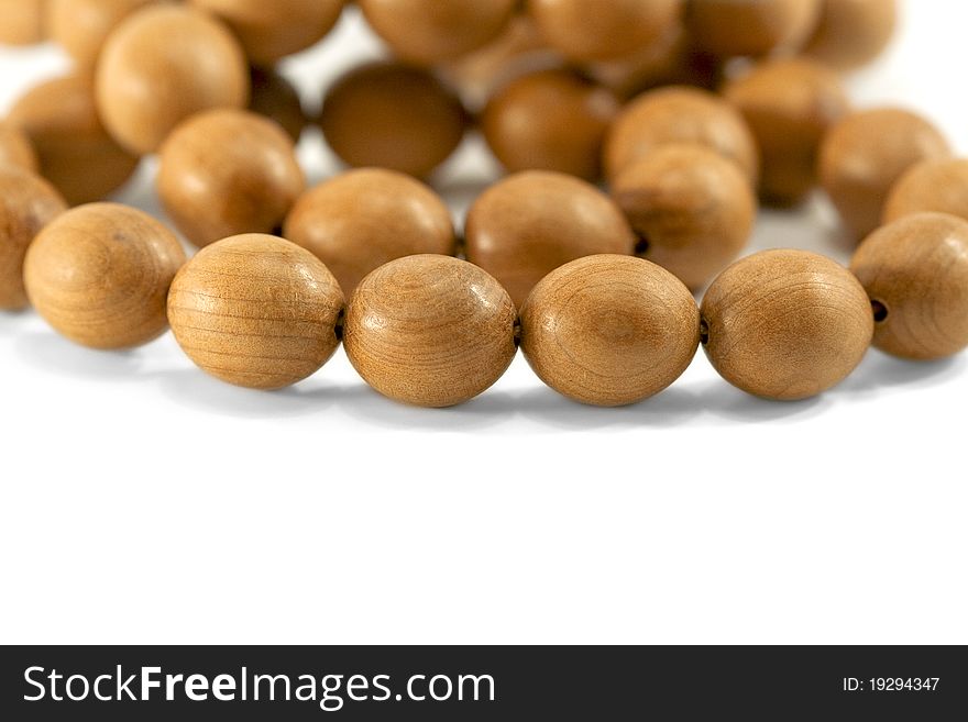 Large wooden beads, varnished, lying on a white background. Large wooden beads, varnished, lying on a white background