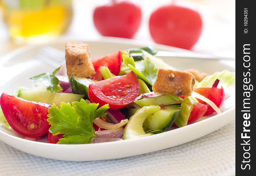 Fresh salad with cucumber, tomatoes, celery and croutons. Fresh salad with cucumber, tomatoes, celery and croutons