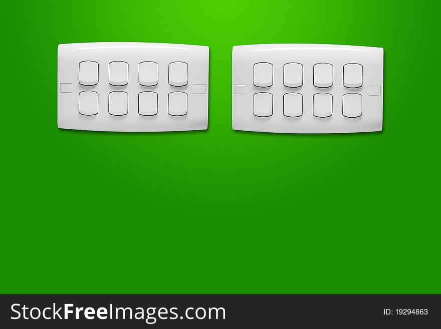 White light switch against a green wall. White light switch against a green wall.