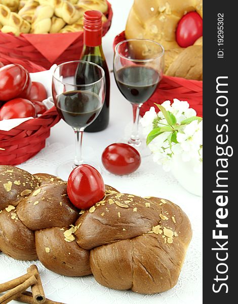 A traditional sweet brioche bread, called tsoureki, decorated with red eggs (Greek recipe). A traditional sweet brioche bread, called tsoureki, decorated with red eggs (Greek recipe)