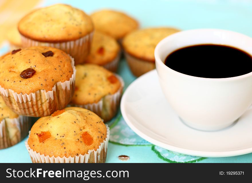 Freshly baked muffins and a white coffee cup. Freshly baked muffins and a white coffee cup