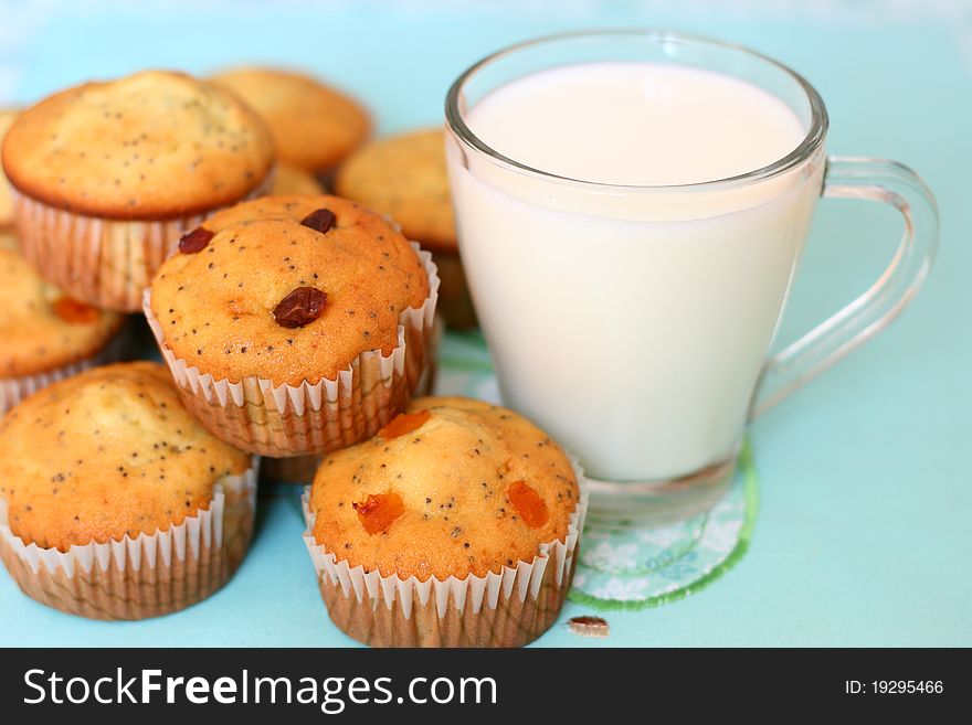 Cup cakes stacked near a glass of fresh milk. Cup cakes stacked near a glass of fresh milk