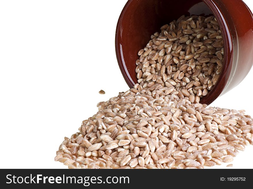 Container upside down with grains of farro. Container upside down with grains of farro