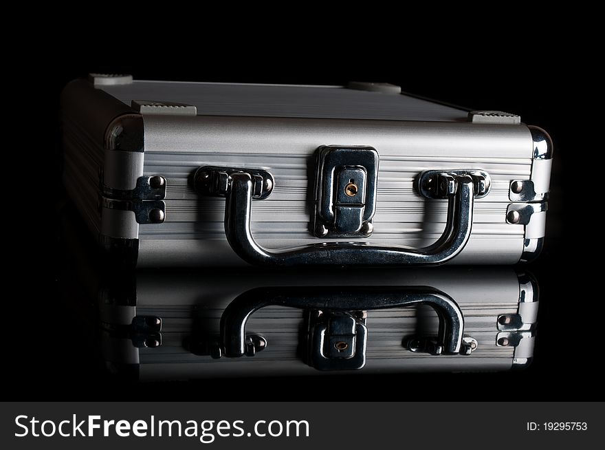 Black suitcase isolated on a black background