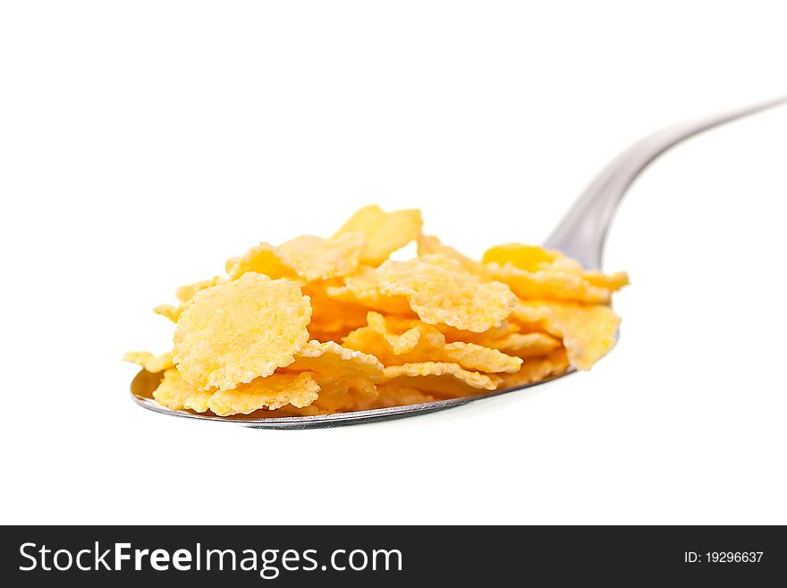 Spoon the corn flakes on a white background. Spoon the corn flakes on a white background.