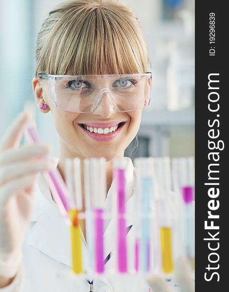 Doctor student  female researcher holding up a test tube in chemistry bright labaratory. Doctor student  female researcher holding up a test tube in chemistry bright labaratory