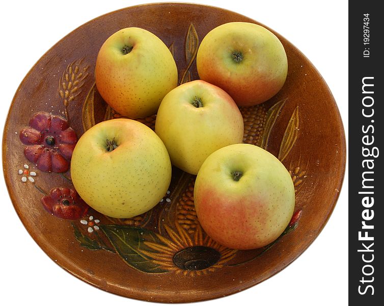 Natural apples on a ceramic, painted plate. Isolated on white background. Natural apples on a ceramic, painted plate. Isolated on white background.