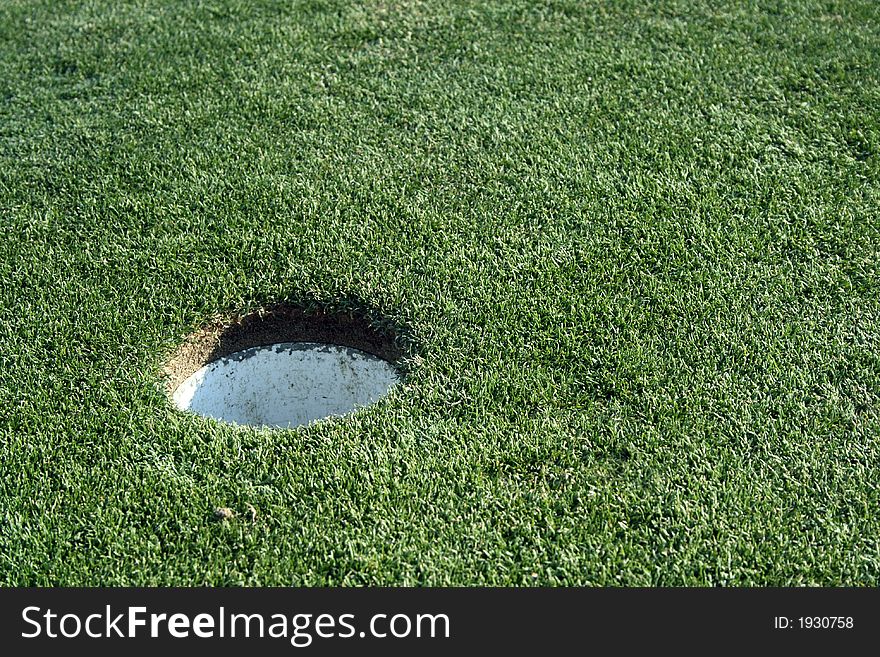 Golf cup on grass golf green