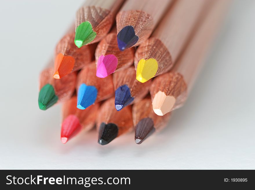 A macro shot of the front end of a group of colored pencils, isolated. A macro shot of the front end of a group of colored pencils, isolated