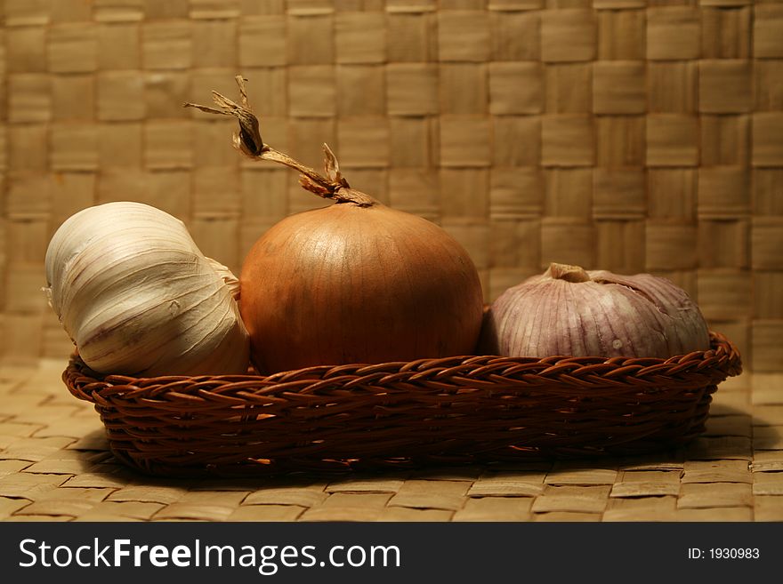 Garlic and onion in small basket.
