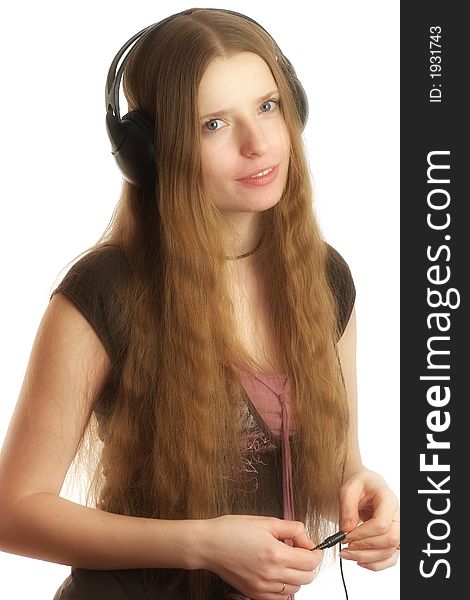 Beautiful young woman listening to music in headphones. Beautiful young woman listening to music in headphones