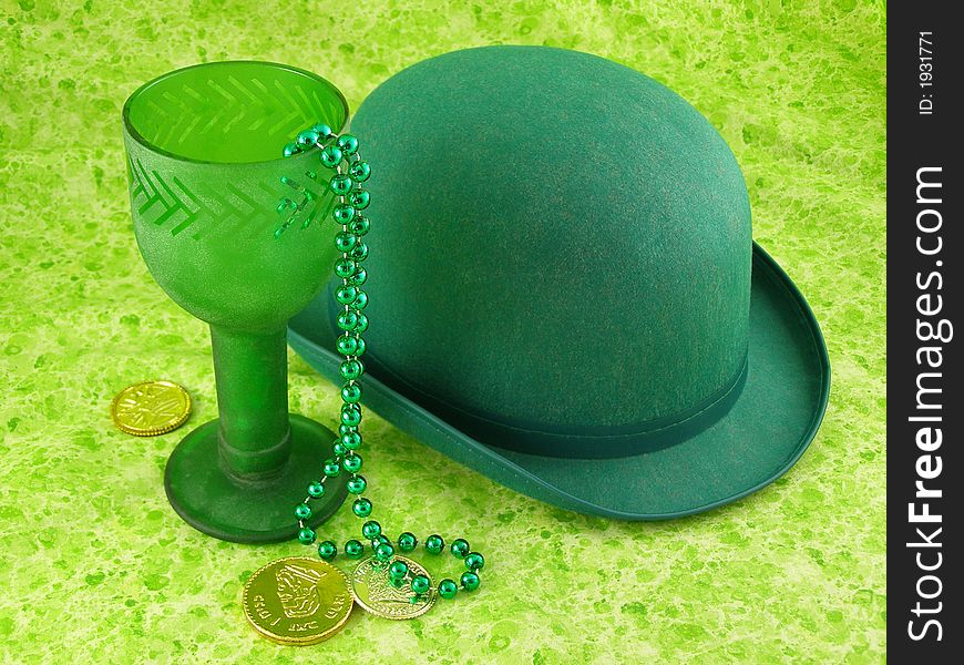 Sparkly green chalice with bowler hat and gold coins. Sparkly green chalice with bowler hat and gold coins