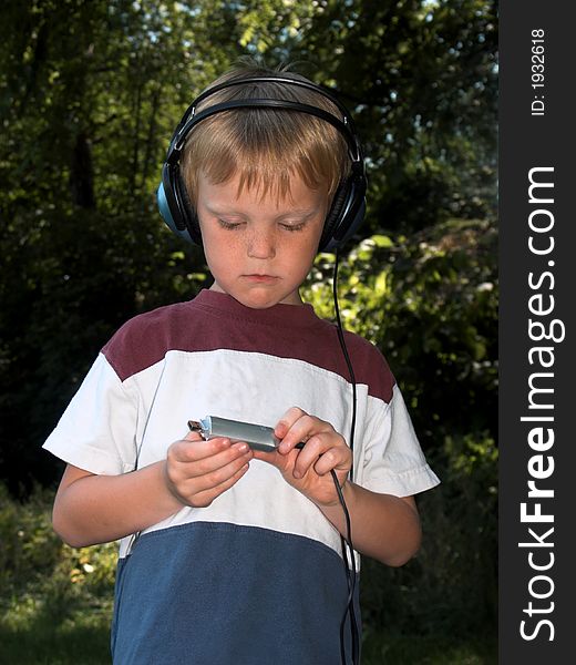 Young blond boy with a mp3 player. Young blond boy with a mp3 player