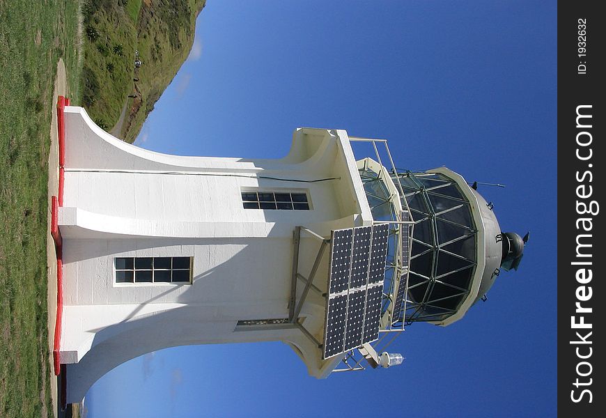 A lighthouse set on the northern tip of New Zealand. A lighthouse set on the northern tip of New Zealand.