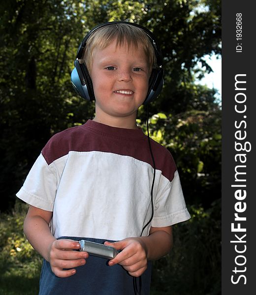 Young blond boy with a mp3 player. Young blond boy with a mp3 player