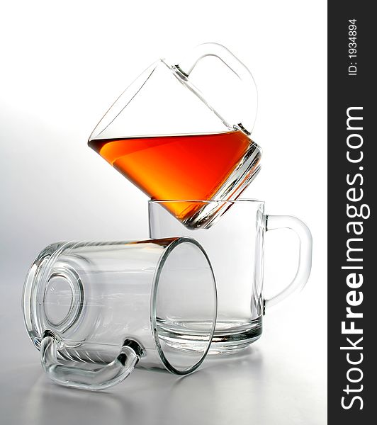 Three glass mugs and black tea, Isolated