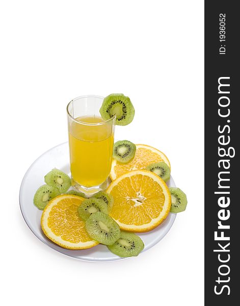 Glass of orange juice and fruits slices on a plate. Glass of orange juice and fruits slices on a plate