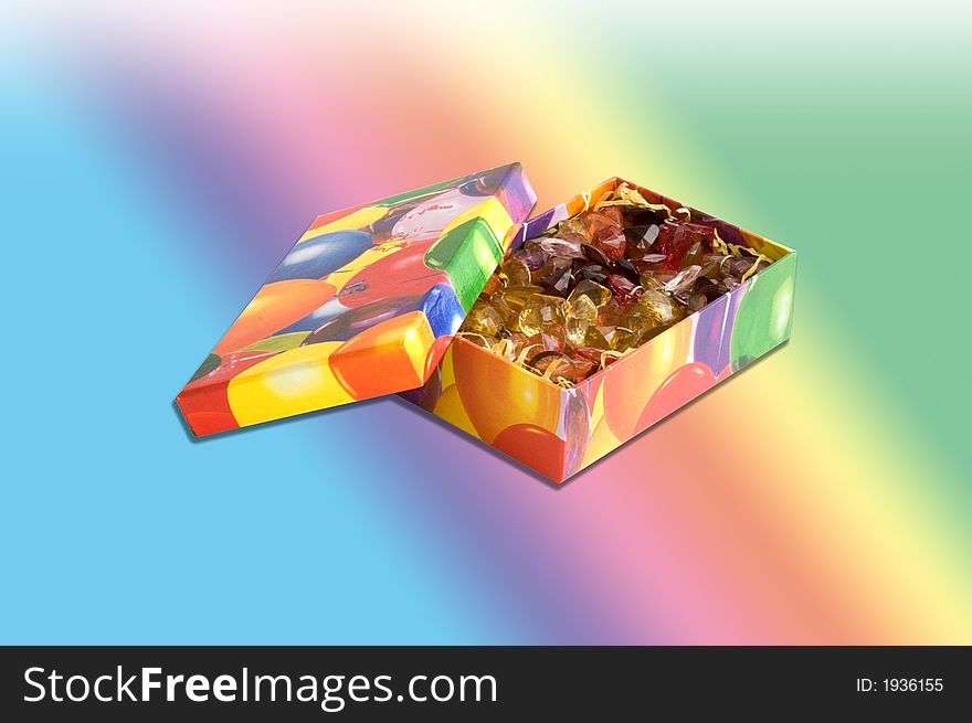 Multicolored gift box with jewels over gradient background