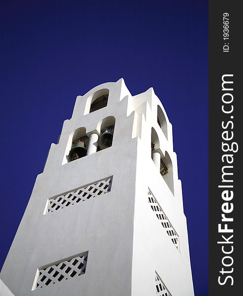 White bell tower of a church Santorini Greece