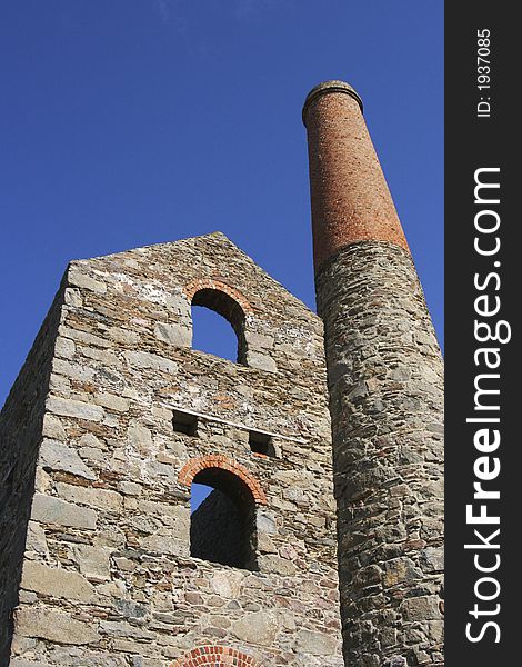 A Cornish pumping engine house framed against a clear blue sky. A Cornish pumping engine house framed against a clear blue sky.
