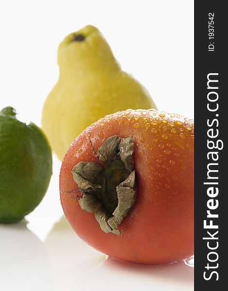 persimmon lime and quince over white background