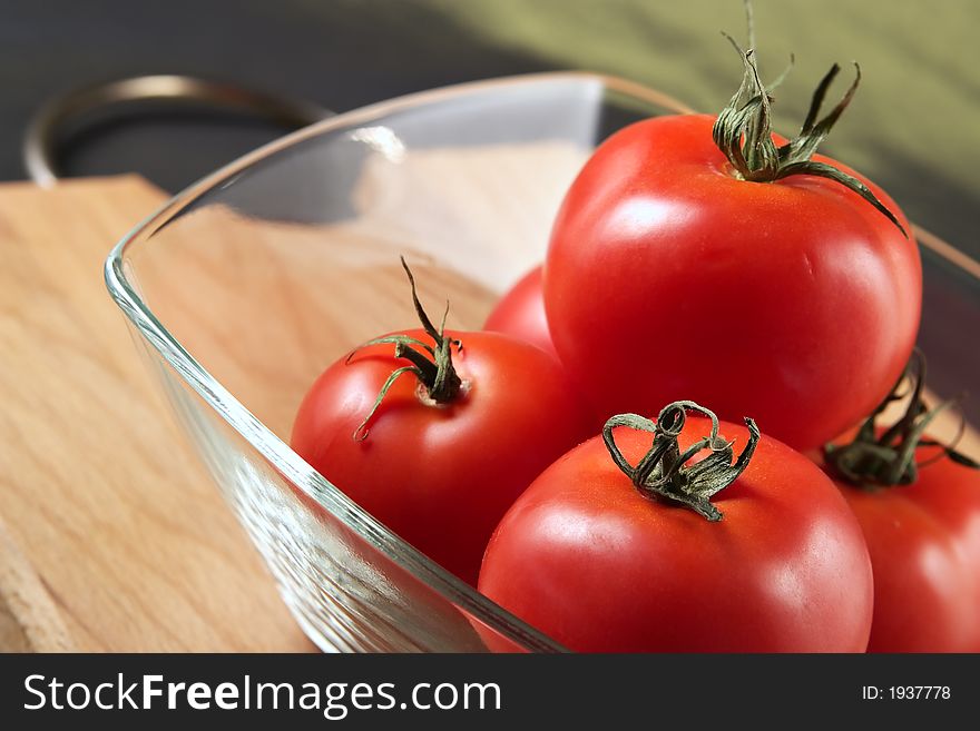 Tomatoes in a glass bowl-ripe component of nutritious vegetable entertainments