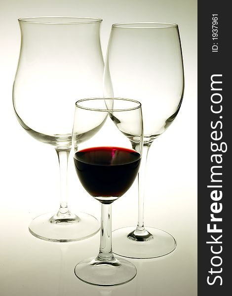 Glass red wine ,  two empty glasses