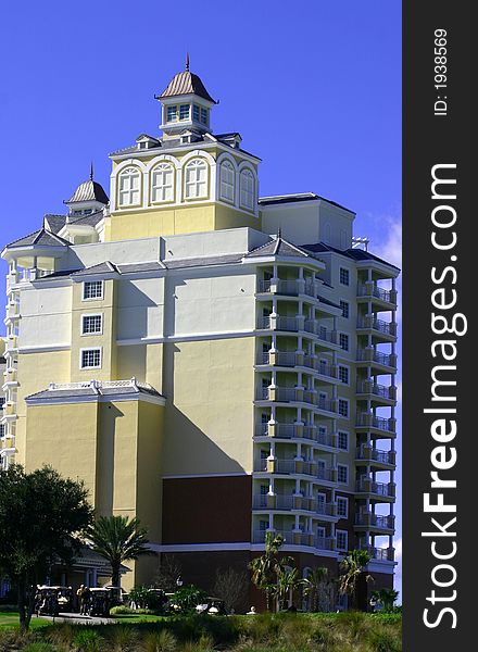 New pale yellow high rise resort hotel against blue sky. New pale yellow high rise resort hotel against blue sky