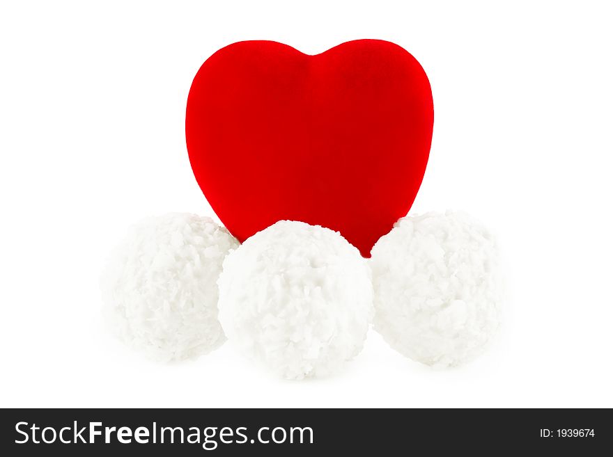 Shot of the red heart on the coconut sweets, on a white background with pretty shadow. Shot of the red heart on the coconut sweets, on a white background with pretty shadow