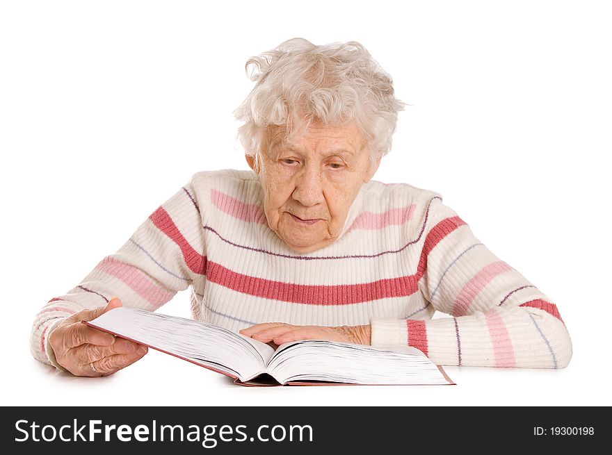 The elderly woman reads the book isolated