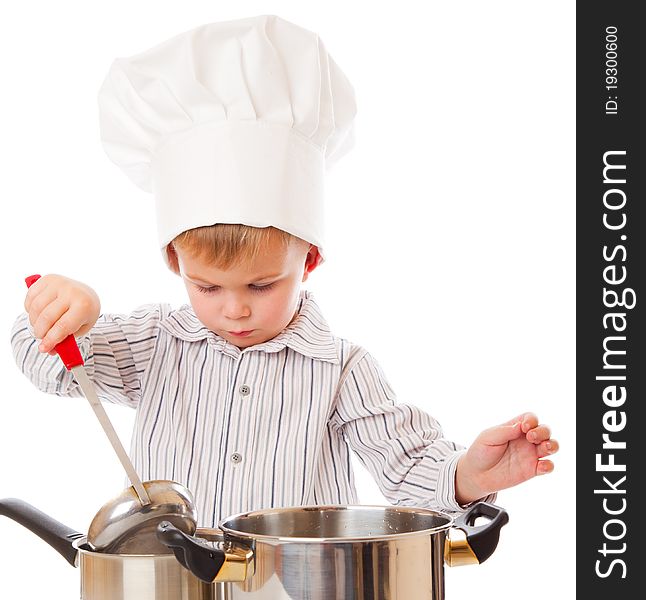 A funny cute boy is portraying a cook. isolated on a white background. A funny cute boy is portraying a cook. isolated on a white background