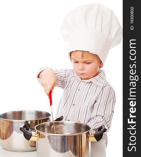 A funny cute boy is portraying a cook. isolated on a white background. A funny cute boy is portraying a cook. isolated on a white background