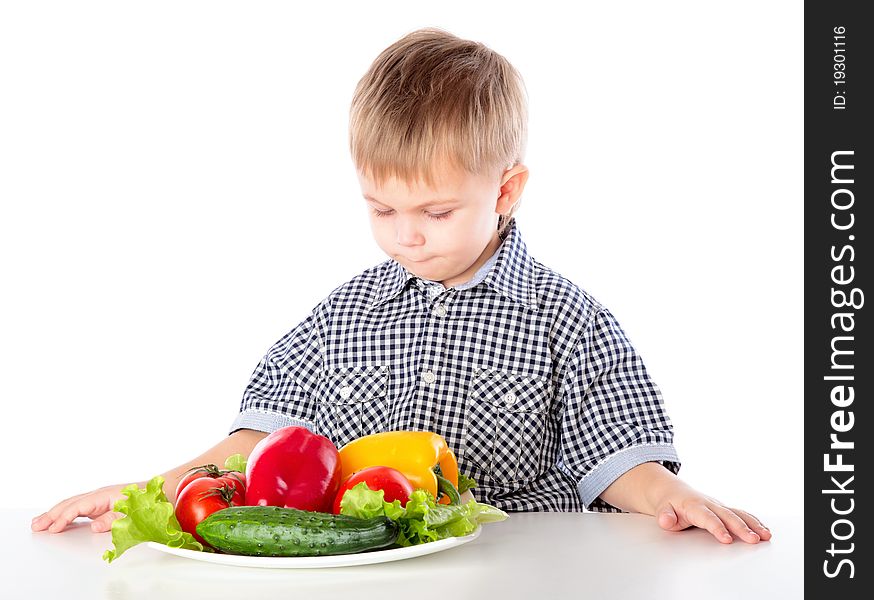 A boy and the plate of vegetables