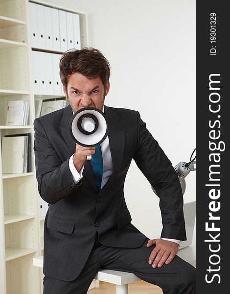 Business man in office with businessman megaphone