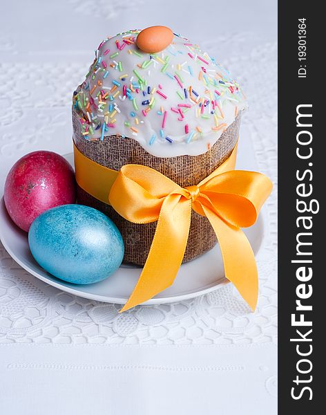 Easter cake and easter eggs on white linen tablecloth, selective focus. Easter cake and easter eggs on white linen tablecloth, selective focus.