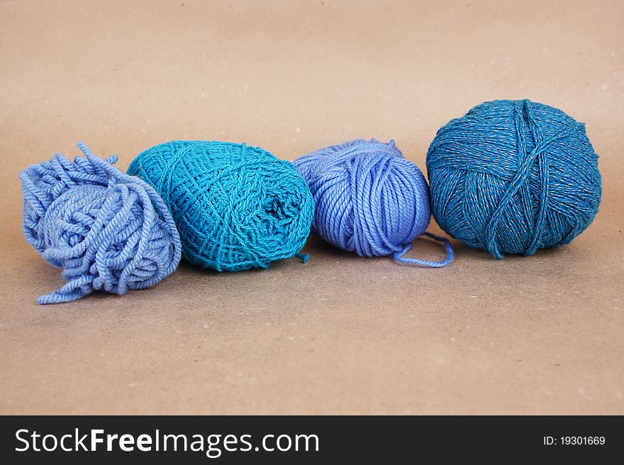 Four blue clews on brown paper background