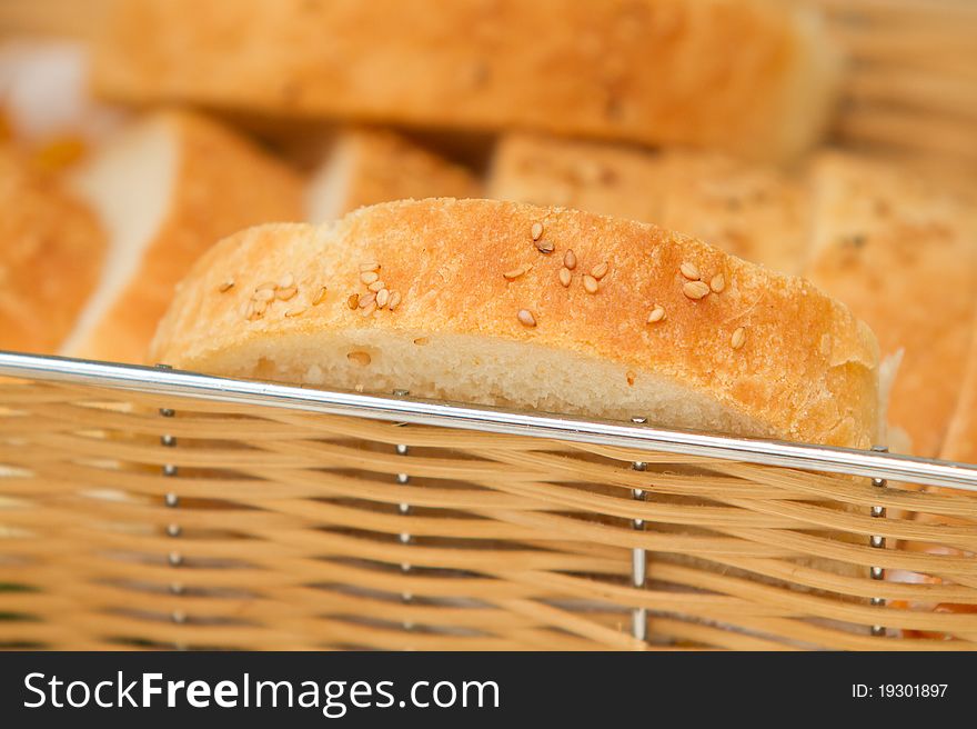 Slices of home made bread with sesame seeds in the basket. Slices of home made bread with sesame seeds in the basket