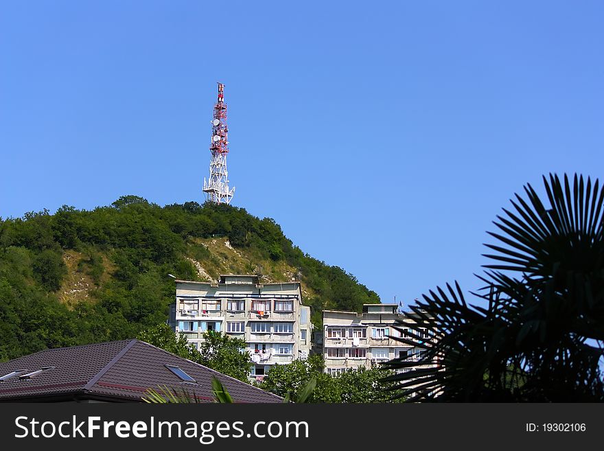 Telecommunication tower and buildings in mountains. The Black Sea coast of Caucasus