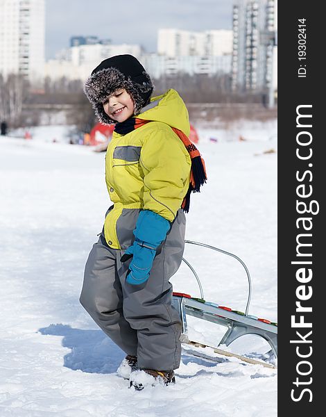 Joyful smiling little boy with sled, winter time. Joyful smiling little boy with sled, winter time