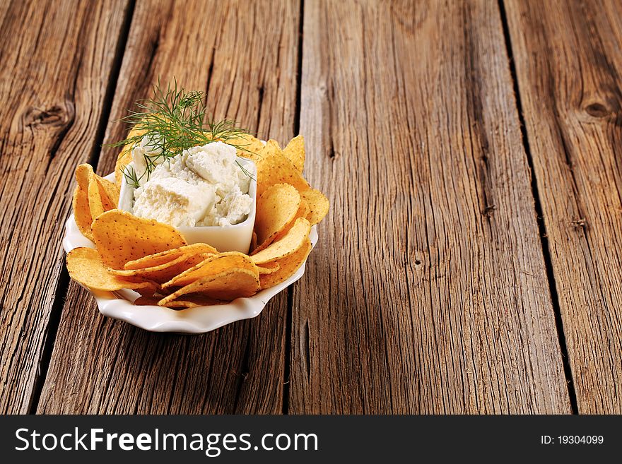 Bowl of corn chips and fresh cheese