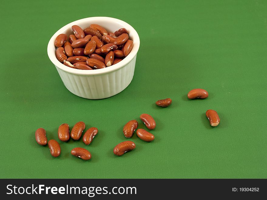 Pot red beans white on green background