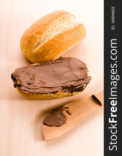 Bread with chocolate cream on the wooden board