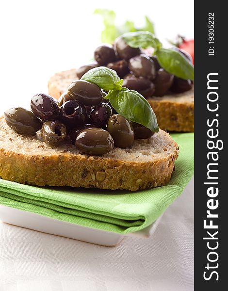 Photo of delicious sliced bread with olives and basil. Photo of delicious sliced bread with olives and basil